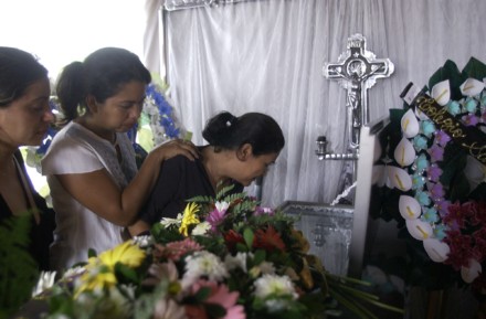 Relatives mourn over Olivas’s coffin