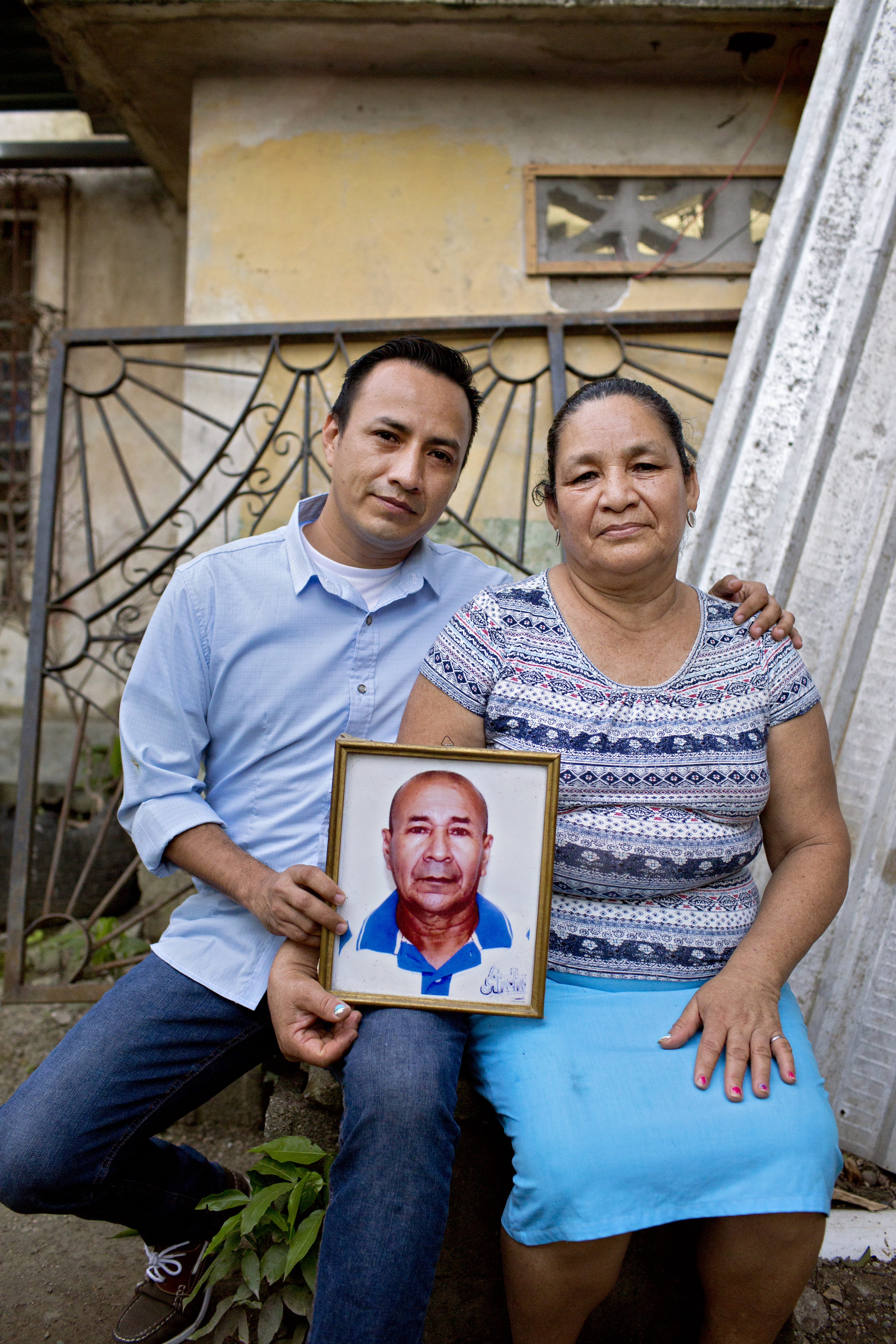 Ángel Lenin Flores and his mother hold a photo of José Ángel, a campesino leader murdered by a paramilitary band that has cropped up in a battle for land between campesino cooperatives and wealthy landowners in the Bajo Aguán region of Honduras